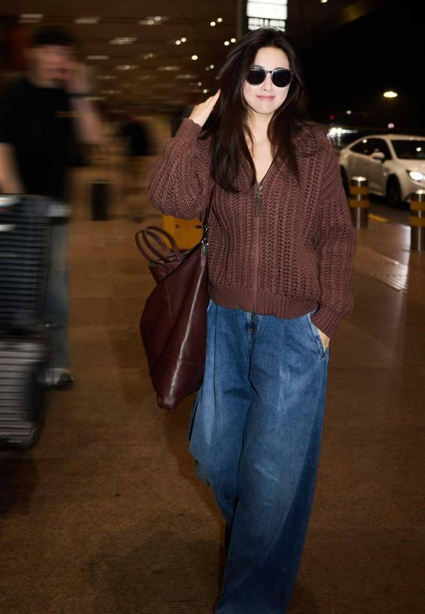 搜狐娱乐讯 近日，一组朱珠米兰时装周机场出发图释出。图中，朱珠穿红棕色外套搭配牛仔裤，随性时尚。