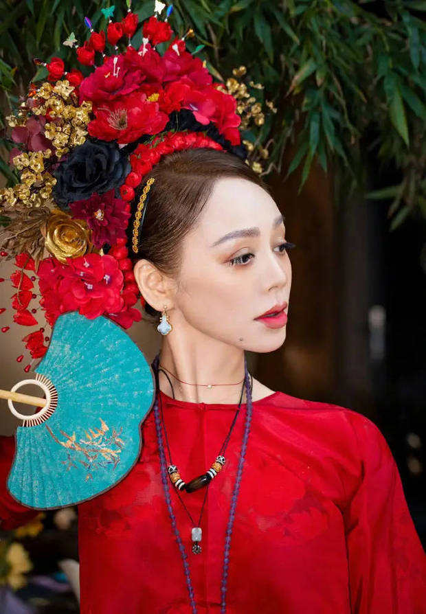 宁静手拿墨蓝色扇子。