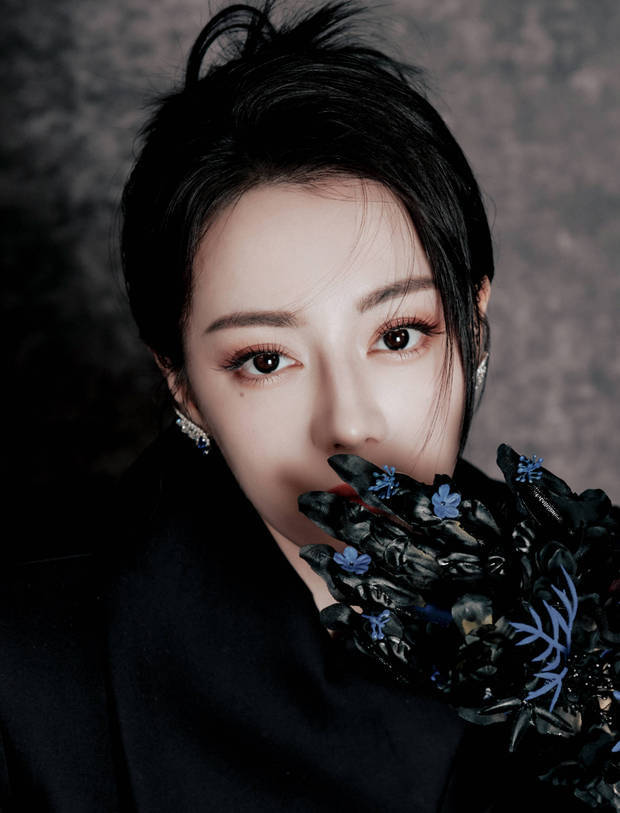 迪丽热巴戴着蓝花手套，神秘又美丽。